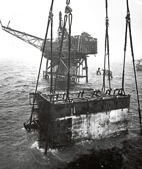 Piper Alpha's main accommodation module being lifted from the North Sea.